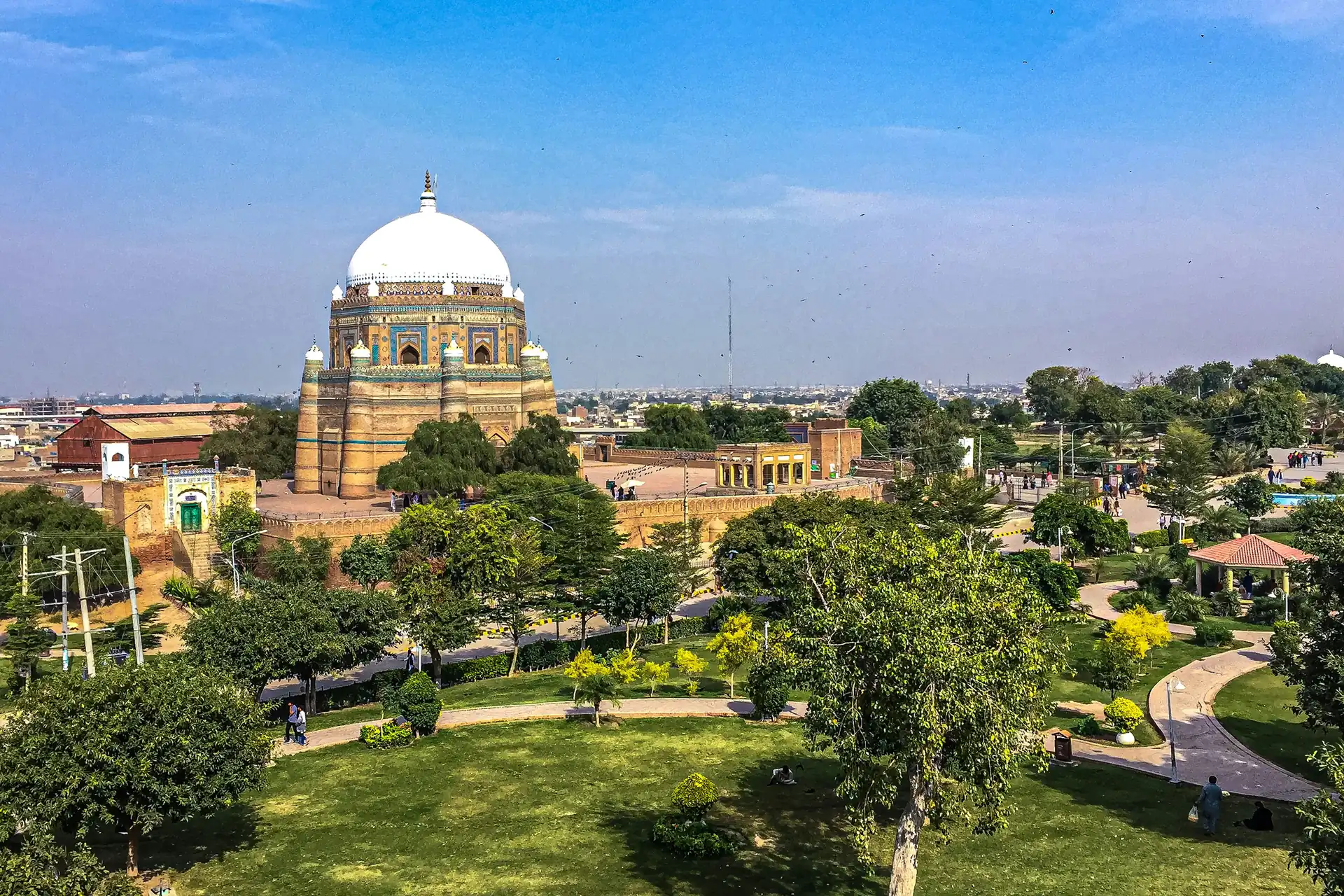 The domed tomb of Shah Rukn-e-Alam rising above a green park in Multan.