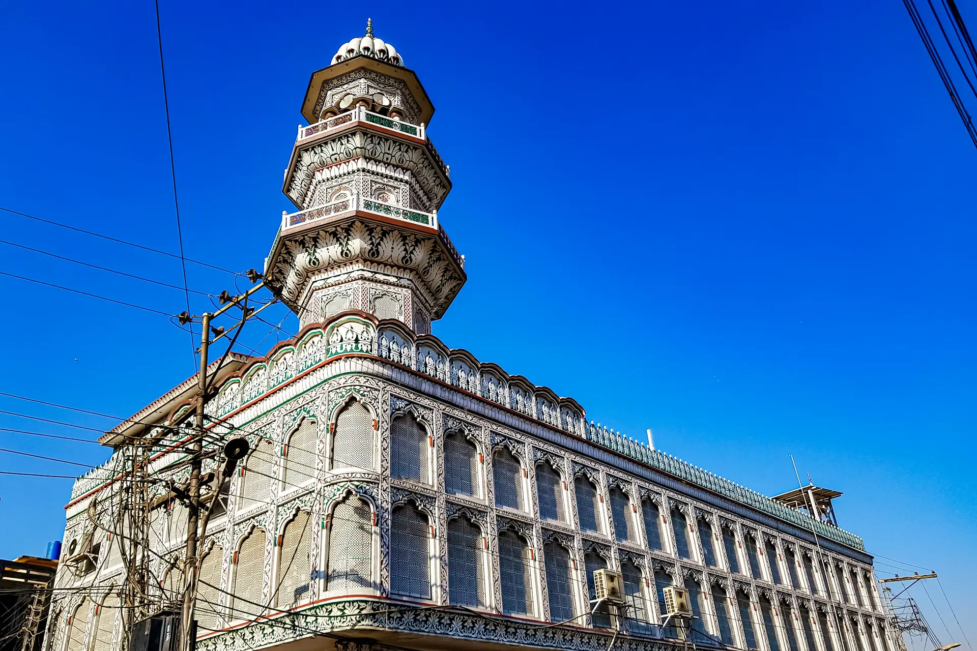 An ornate heritage building and its minaret on Jamia Masjid Road in Rawalpindi.